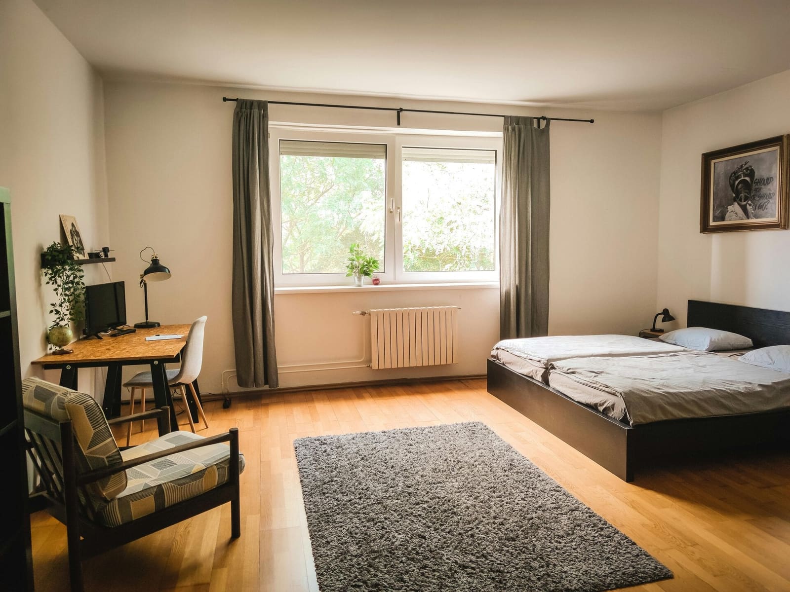 Dormitorio luminoso con cama doble, escritorio y butaca